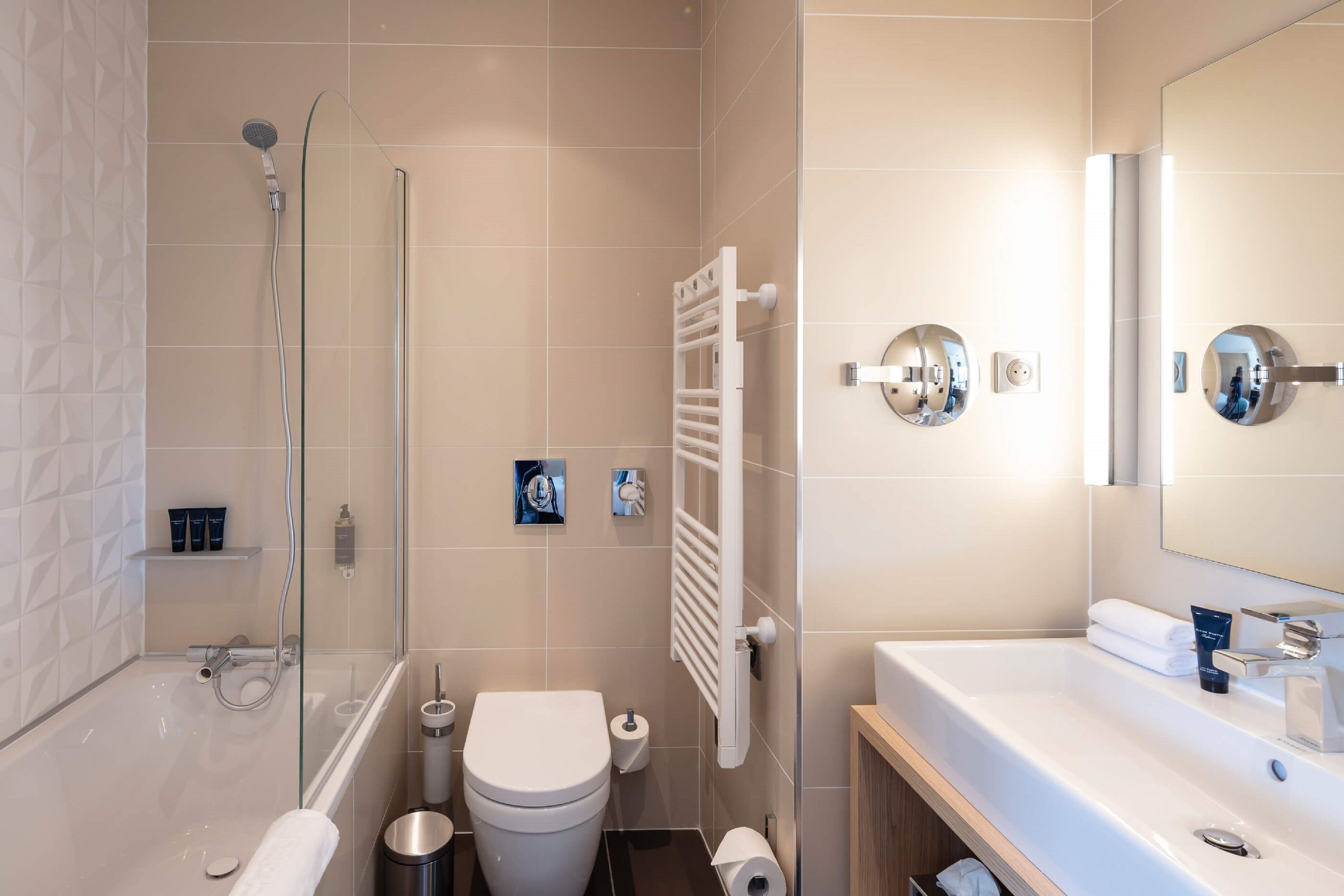 deluxe suite | bathroom | rainfall showerhead, designer toiletries, hair dryer, slippers