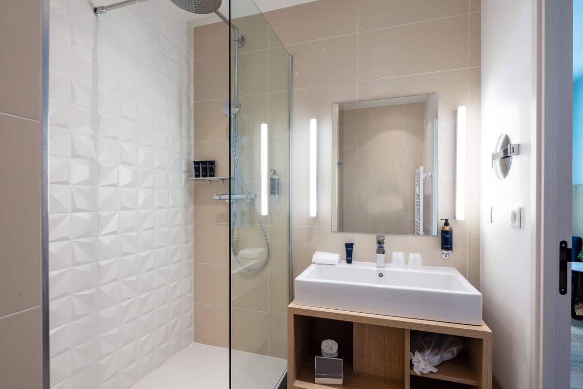 rainfall showerhead, designer toiletries, hair dryer, slippers