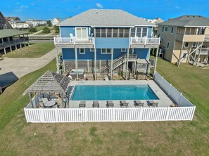 A two-story house with a swimming pool, a deck, and a fenced patio area. - Wise Choice: Semi-oceanfront | Private Pool | Spa (Nags Head)