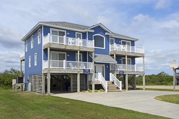 A two-story building with a blue exterior and white railings. It has a sign indicating it is for sale. - Wise Choice: Semi-oceanfront | Private Pool | Spa (Nags Head)