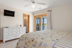 A bedroom with a bed, a dresser, a ceiling fan, and a television. - Wise Choice: Semi-oceanfront | Private Pool | Spa (Nags Head)