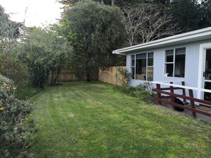 Terrace/patio - Fully fenced family and pet friendly iconic kiwi bach awaits (Foxton Beach)