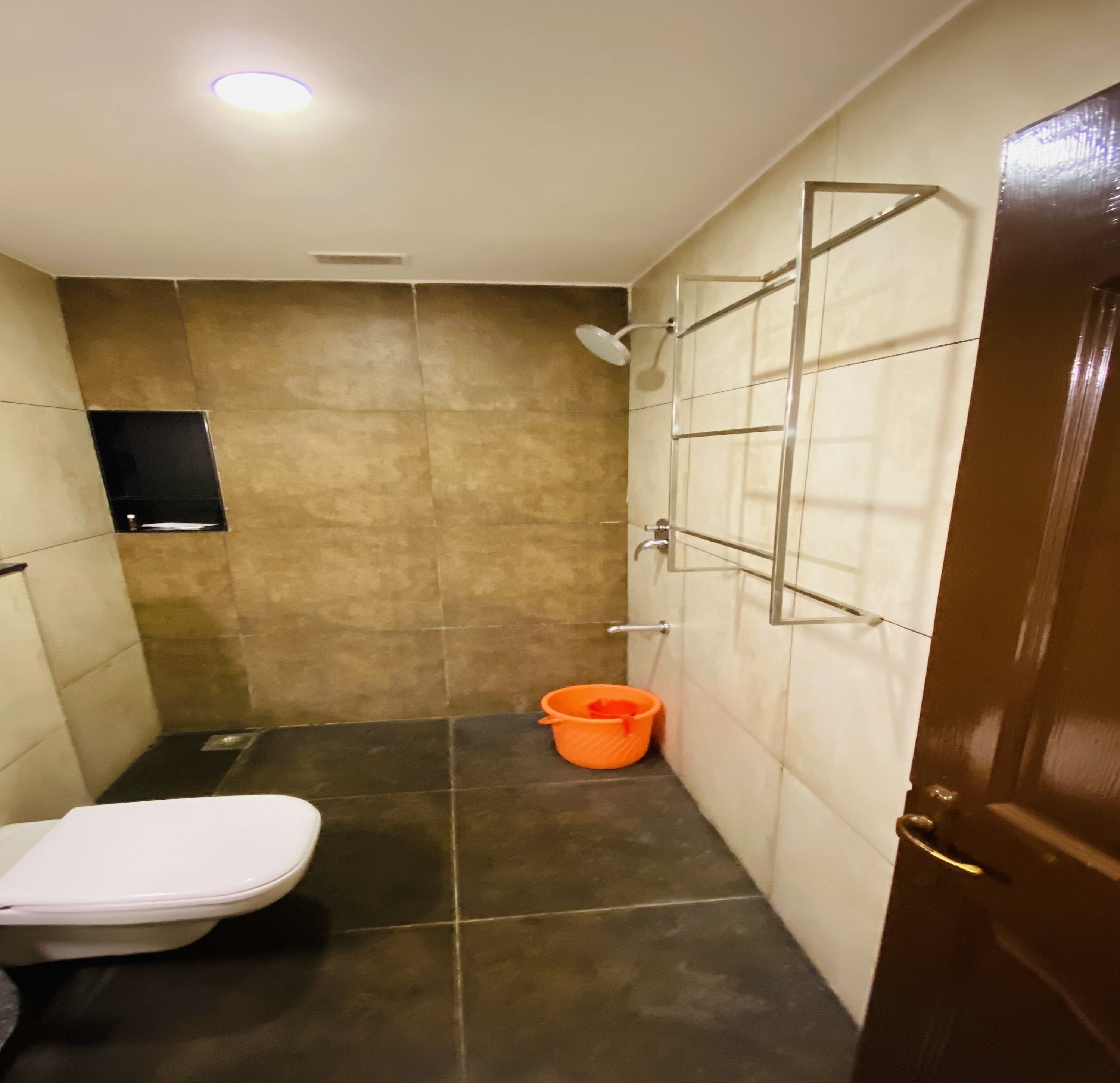 A small bathroom with a toilet, a shower, and a sink.