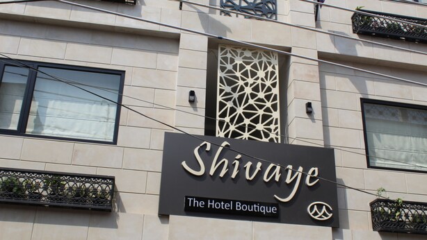 A building with a sign that reads "Shivaje The Hotel Boutique".