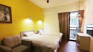 A hotel room with a bed, a sofa, a desk, and a window with curtains. - Donghae13.8 (Taichung)