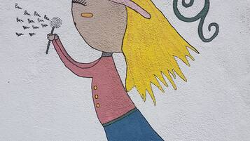 A cartoon character with a cat, a dandelion, and a butterfly.