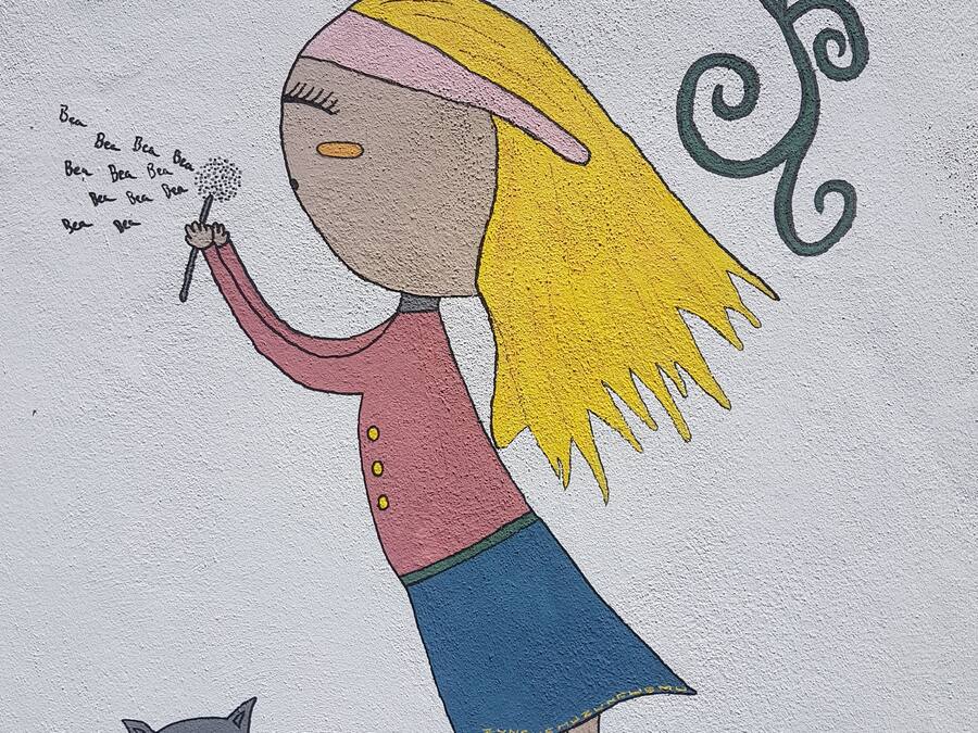 A cartoon character with a cat, a dandelion, and a butterfly.