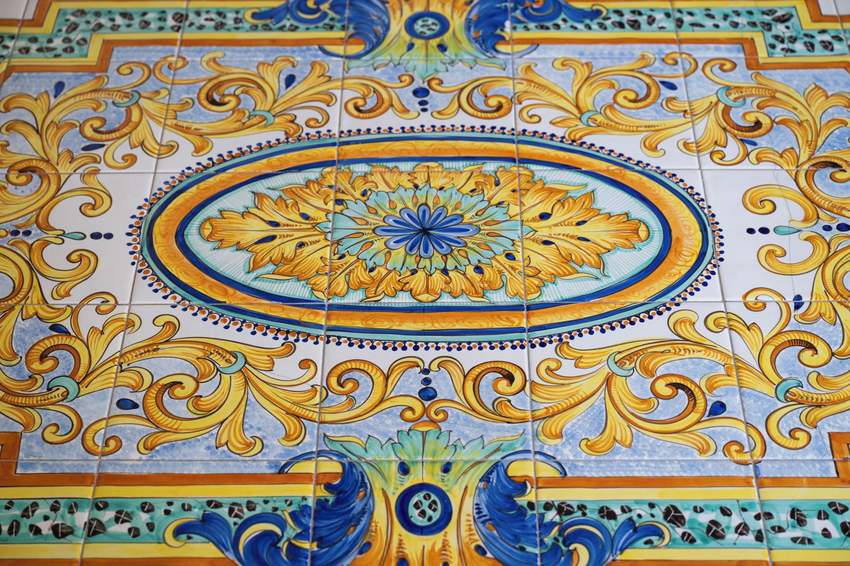A detailed tile pattern with a central floral motif surrounded by ornate designs.