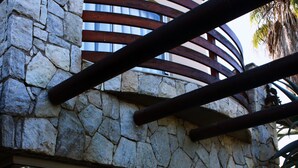 A stone wall with a window and a metal railing. - Paradise At Rossmund Golf 5 Swakopmund (Swakopmund)