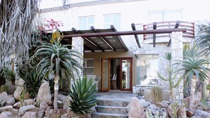 A stone staircase leading to a building entrance, surrounded by various cacti and succulents. - Paradise At Rossmund Golf 5 Swakopmund (Swakopmund)