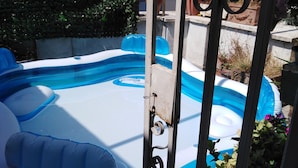 An inflatable pool with a blue and white color scheme, surrounded by a metal fence with decorative elements. - B&B Parioli Roma (Rome)