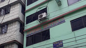 A multi-story building with signs for Hotel As Shams International and other businesses. - Hotel As Shams international (Dhaka)