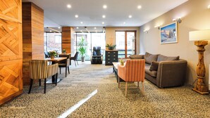 A modern interior with a dining area, sofa, and a lamp. - Predela LUX (Bansko)