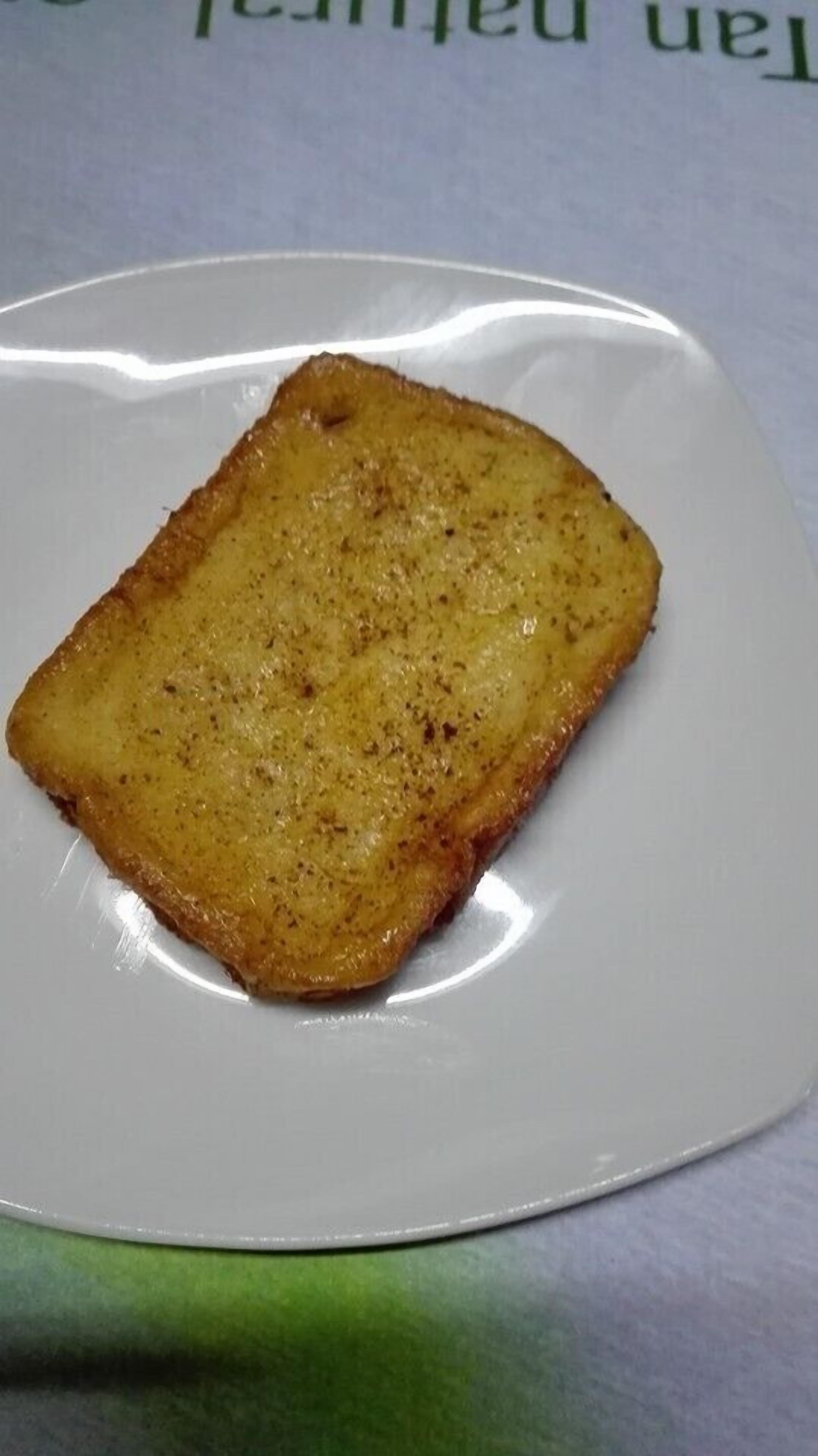 A single slice of toasted bread on a white plate.