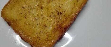 A single slice of toasted bread on a white plate.