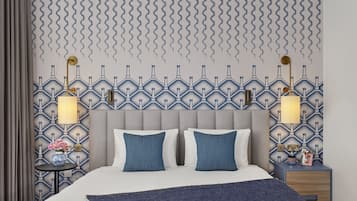 A modern hotel room with a large bed, two bedside tables with lamps, a patterned wallpaper, and a decorative wall panel.