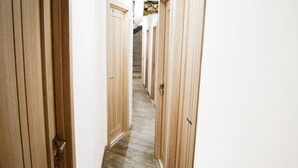 A narrow hallway with wooden doors and a tiled floor. - Hostel Train Station (Kyiv)