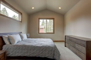 A bedroom with a bed, a dresser, a window, and a ceiling with recessed lighting. - Kangaroo Loop - Closest to Bachelor! 5BR/3.5BA, Jacuzzi (Bend)