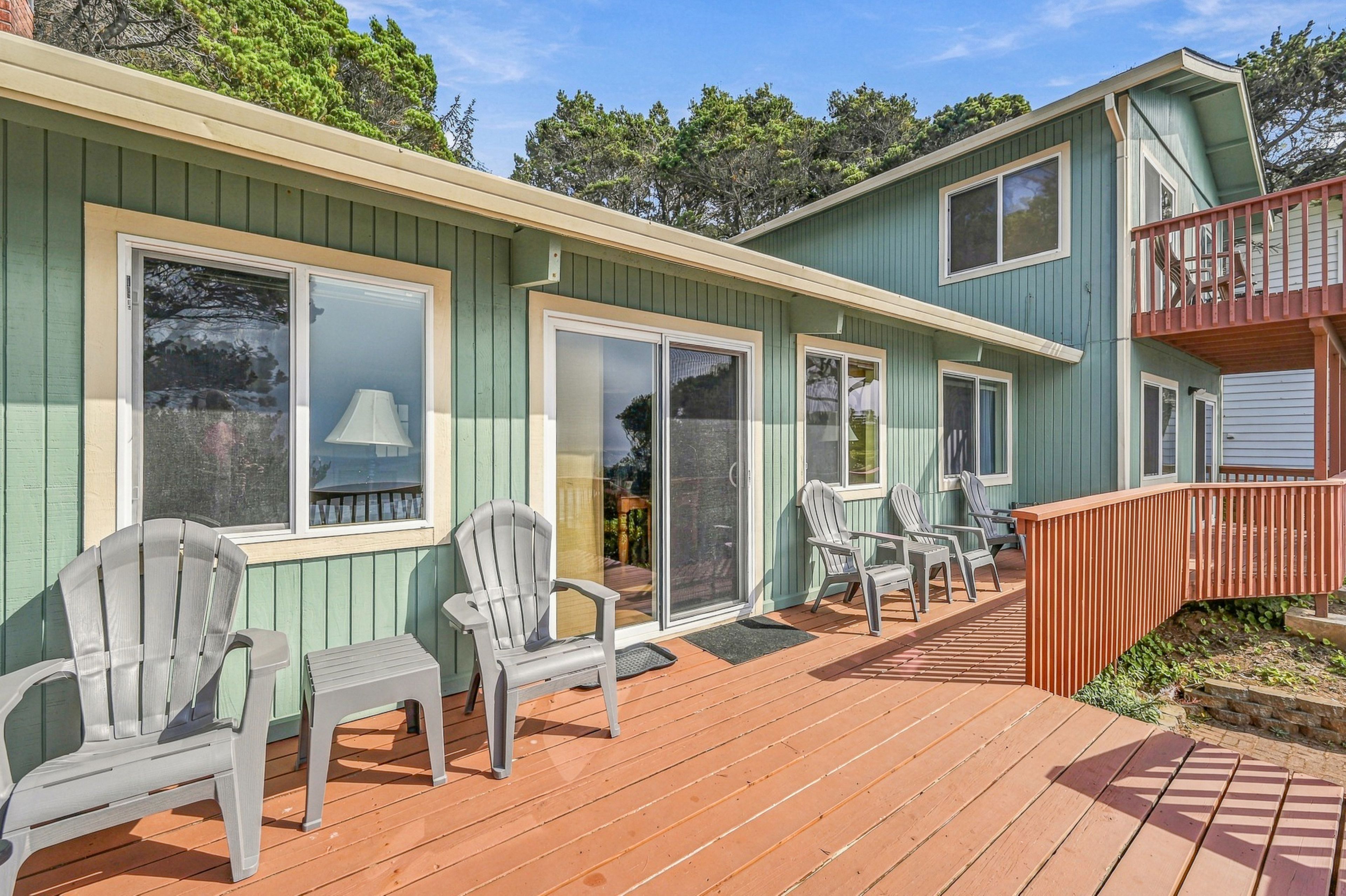 A wooden deck with outdoor seating and a covered area.