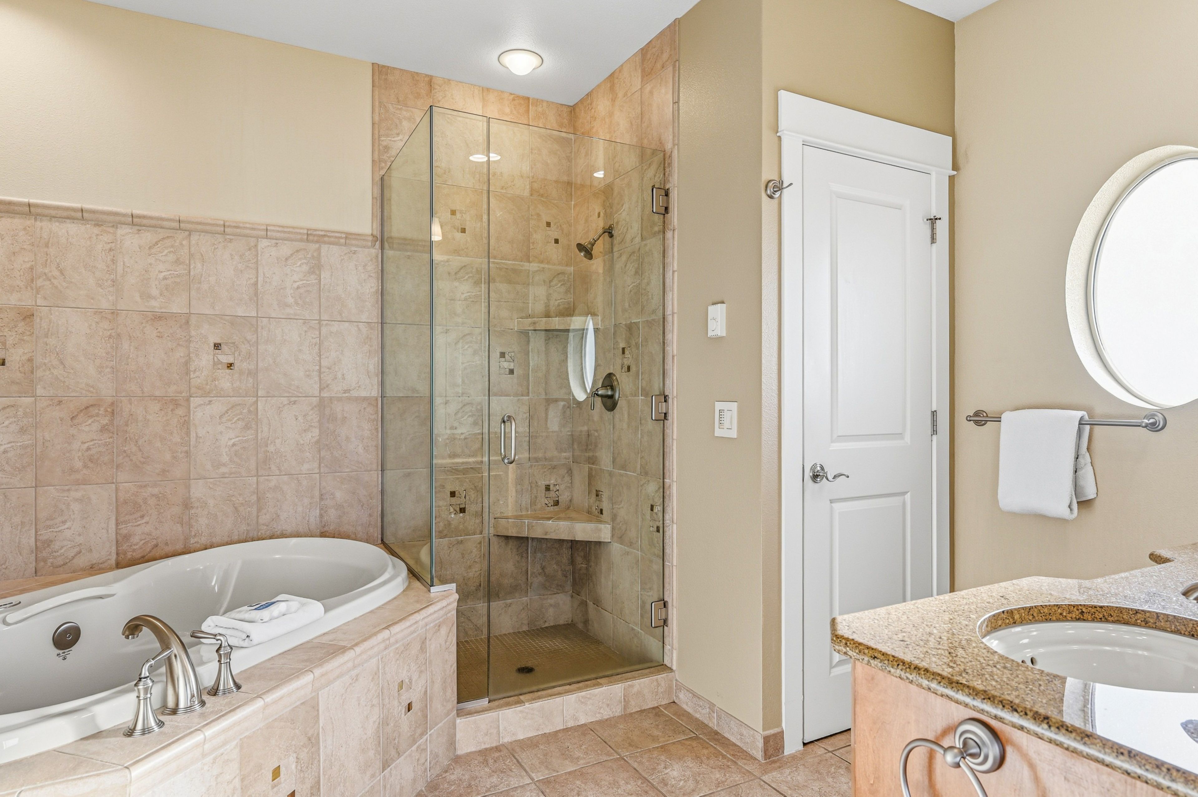 A modern bathroom with a walk-in shower, a freestanding bathtub, and a vanity with a sink.