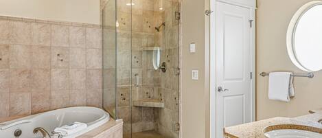 A modern bathroom with a walk-in shower, a freestanding bathtub, and a vanity with a sink.