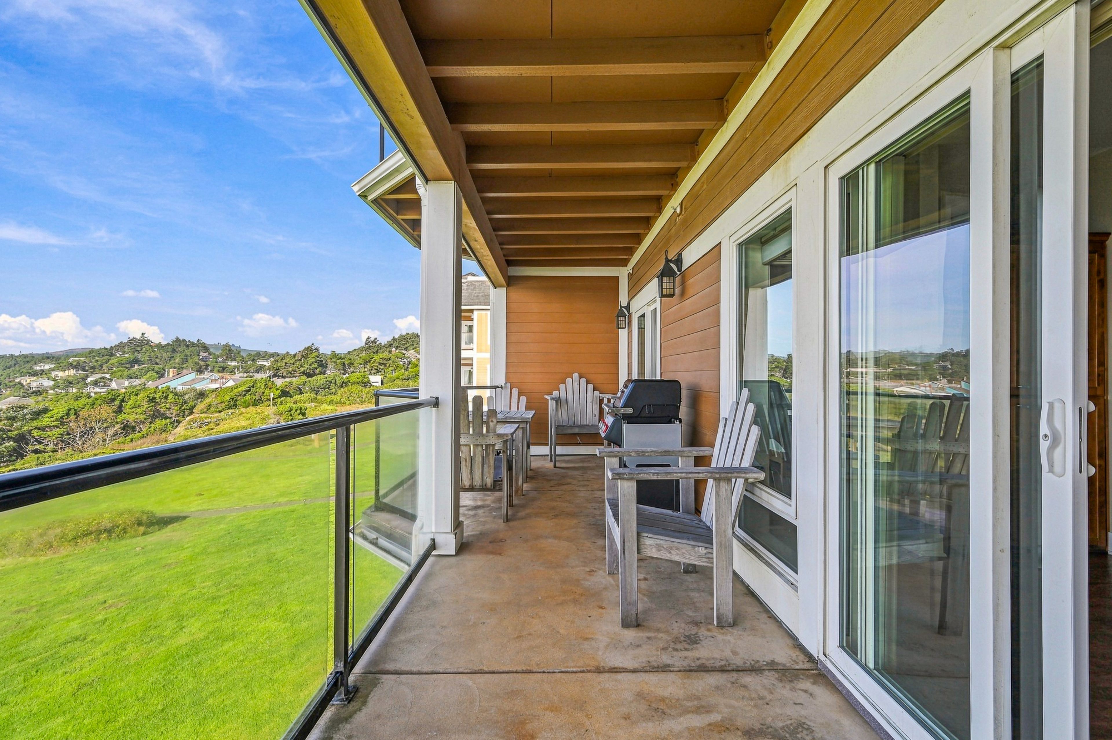 Step out onto your private balcony, where Adirondack chairs frame sweeping views of lush greenery and open skies—a serene spot to sip morning coffee or unwind as the day fades.