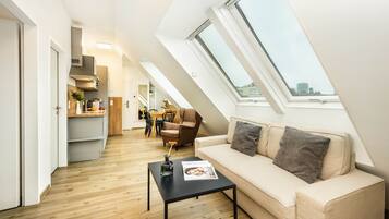 Suite, 2 Bedrooms, Balcony | Living area | Flat-screen TV, heated floors