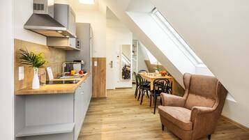 Suite, 2 Bedrooms, Balcony | Living area | Flat-screen TV, heated floors