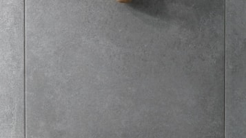 A tiled floor with three wooden cone-shaped objects.