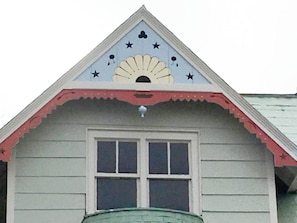 Stylish single-story building with a central window and decorative sun motif.