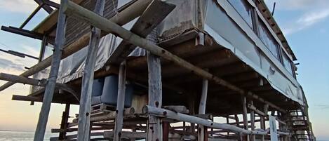 A structure with a sign reading "SILK & SALOMON" on a pier extending over water.