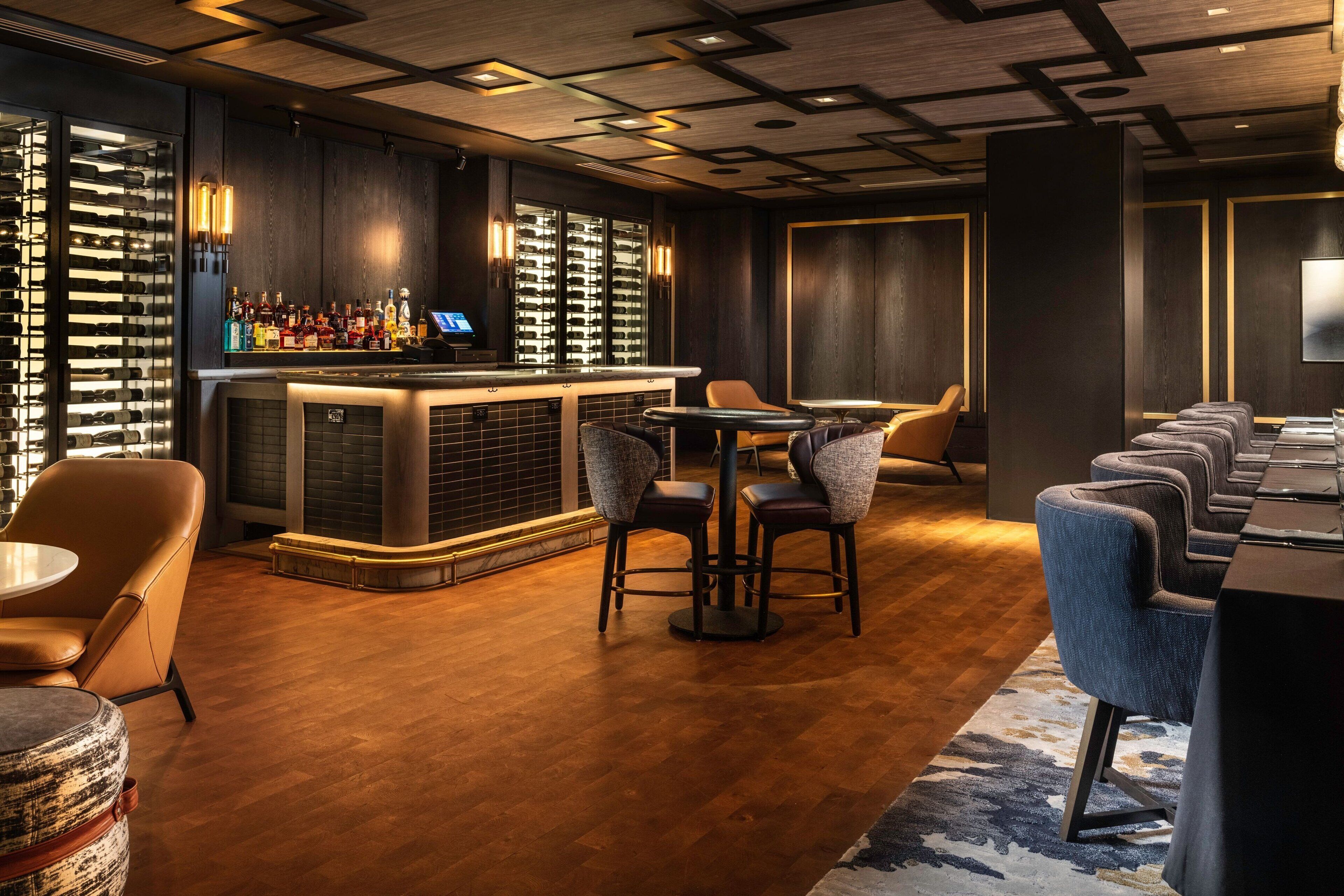 A bar area with a wine rack, bar counter, and seating.