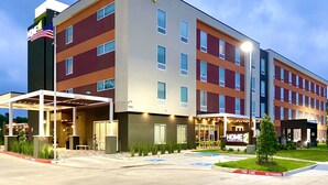 A multi-story hotel with a modern design, featuring a prominent sign for 'Home 2 Suites by Hilton'. - Home2 Suites by Hilton Beaumont (Beaumont)