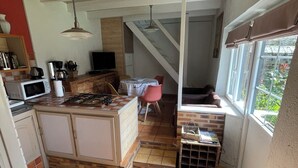 A kitchen with a gas stove, microwave, and wooden cabinets.