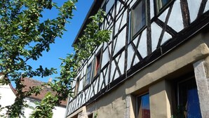 Un edificio tradicional con entramado de madera, paredes de piedra y techo inclinado.