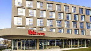 A modern hotel building with a flat facade, large windows, and a prominent 'ibis Hotel' sign. - Ibis Wels (Wels)