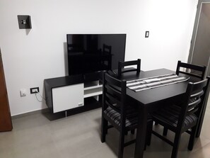 Enjoy meals in this cozy dining area with a flat-screen TV and ample storage.