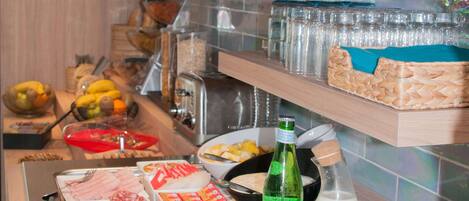 A buffet setup with various food items and beverages.