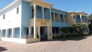 Um edifício de dois andares com uma placa que diz 'Golden Shore Resort'.