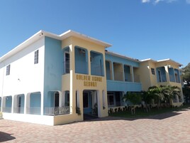 A two-story building with a sign reading "Golden Shore Resort".