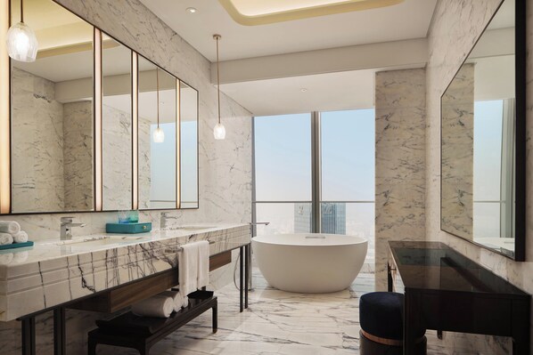 A modern bathroom with a large mirror, marble countertops, a freestanding bathtub, and a view of the city. - Na Lotus Hotel, a Luxury Collection Hotel, Nanning (Nanning)