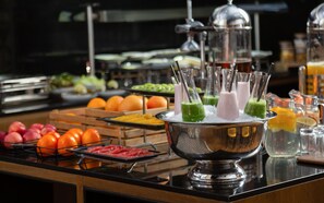 Un buffet proposant une variété de fruits, de légumes et de boissons.