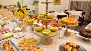 A buffet with various food items including fruits, pastries, and desserts. - Ubaense Plaza Hotel (Uba)