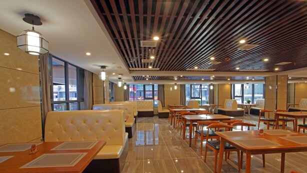 A modern hotel lobby with seating areas, a high ceiling with wooden slats, and large windows offering views of the city. - Days Hotel Zhangjiajie (Zhangjiajie)