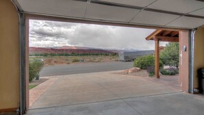 A garage entrance with a view of a road and distant mountains. - Southgate 2 by MoabCondos4Rent (Moab)