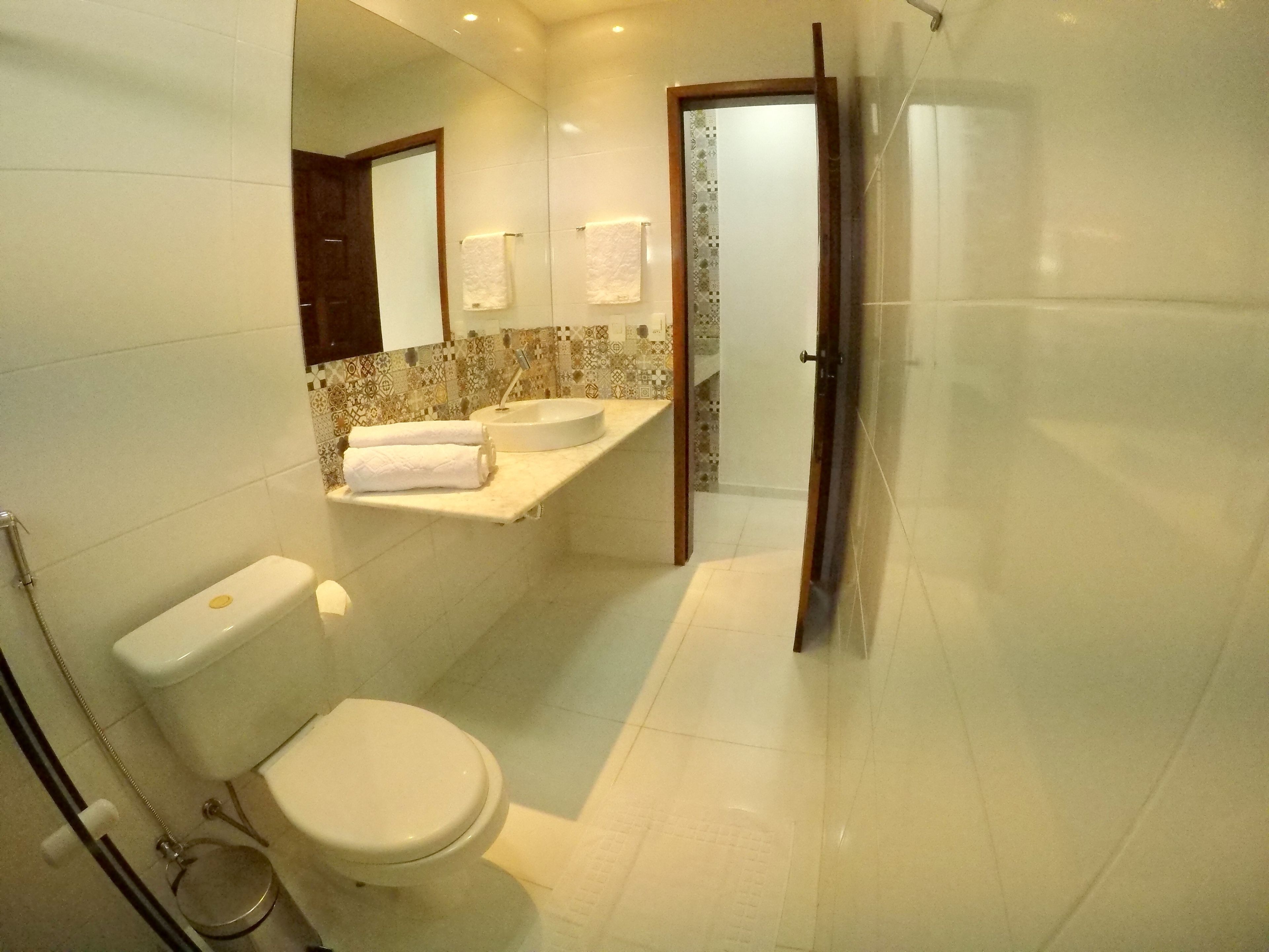 A modern bathroom with a toilet, sink, and shower area.