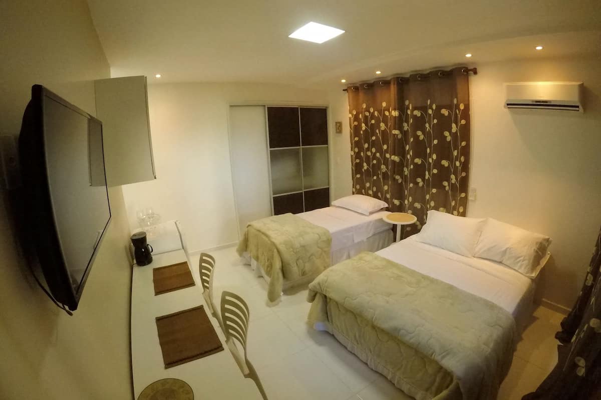 Deluxe Quadruple Room | Minibar, desk, blackout drapes, iron/ironing board