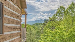 A log cabin with a balcony overlooking a forested mountain landscape. - Mount LeConte Views, Genuine Log Cabin, Hot Tub, Easy Access Near Town, Fire Pit (Gatlinburg)