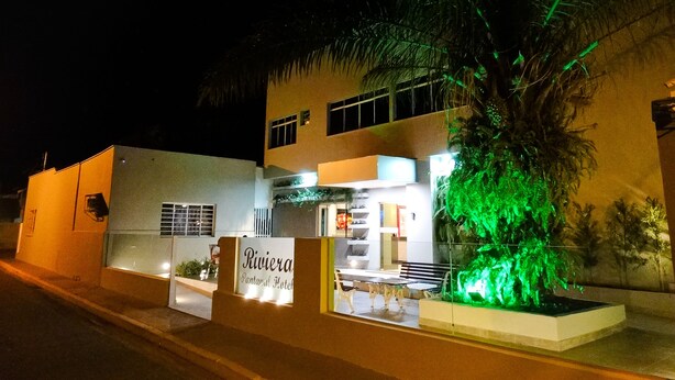 A two-story building with a sign for 'Riviera Pantanal Hotel'. - Riviera Pantanal Hotel (Caceres)