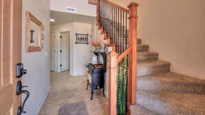 A staircase with wooden railings and a carpeted landing area.